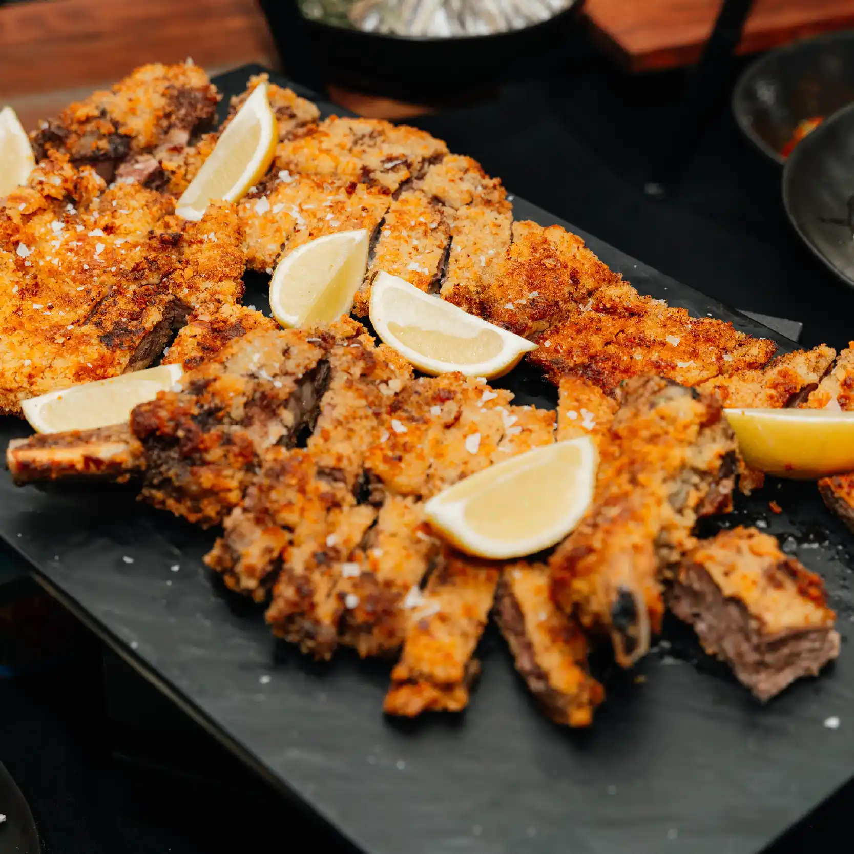 delicious catering crispy lamp with cutted lemon